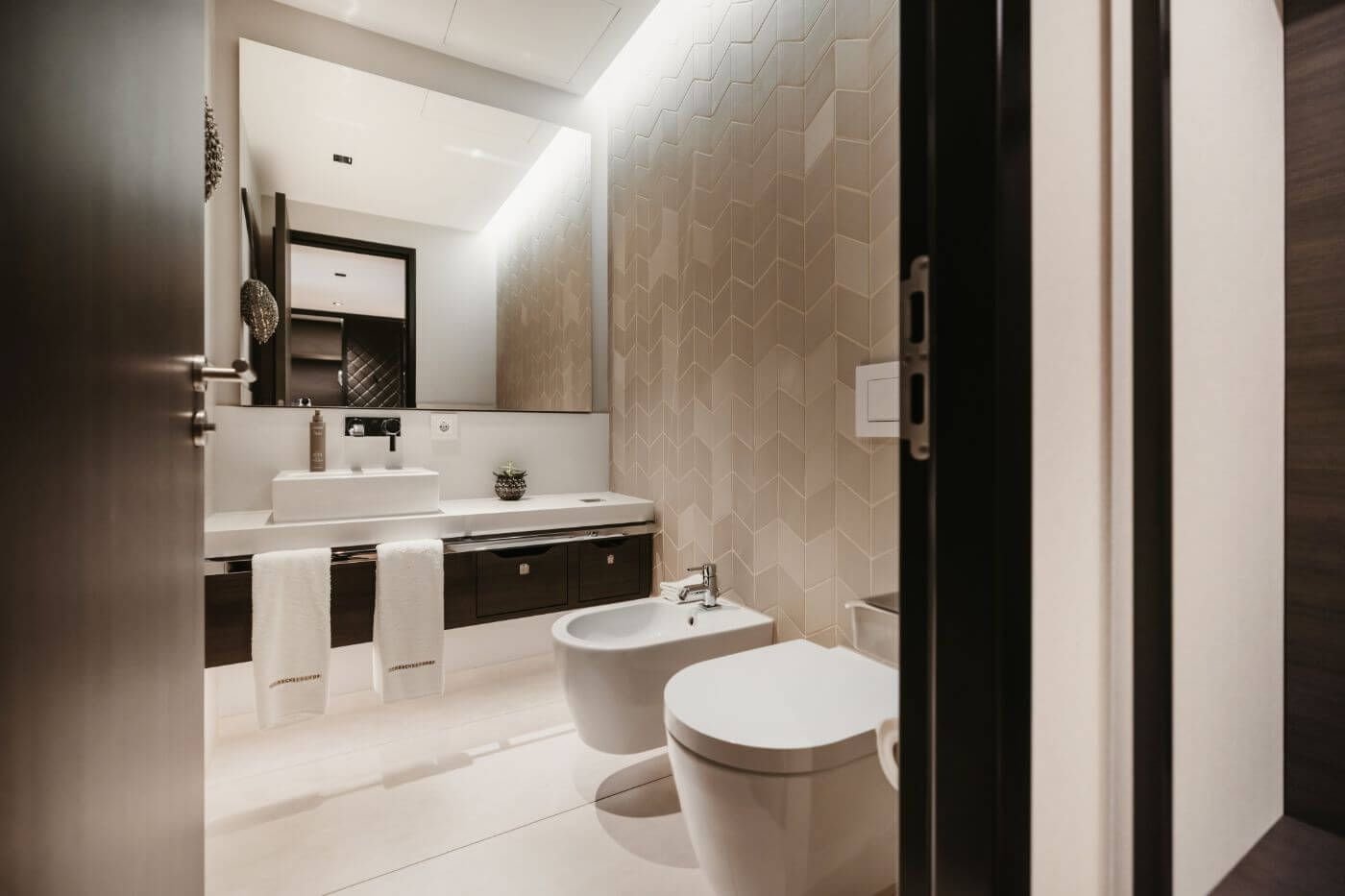 View of the bright bathroom with large mirror, WC and bidet