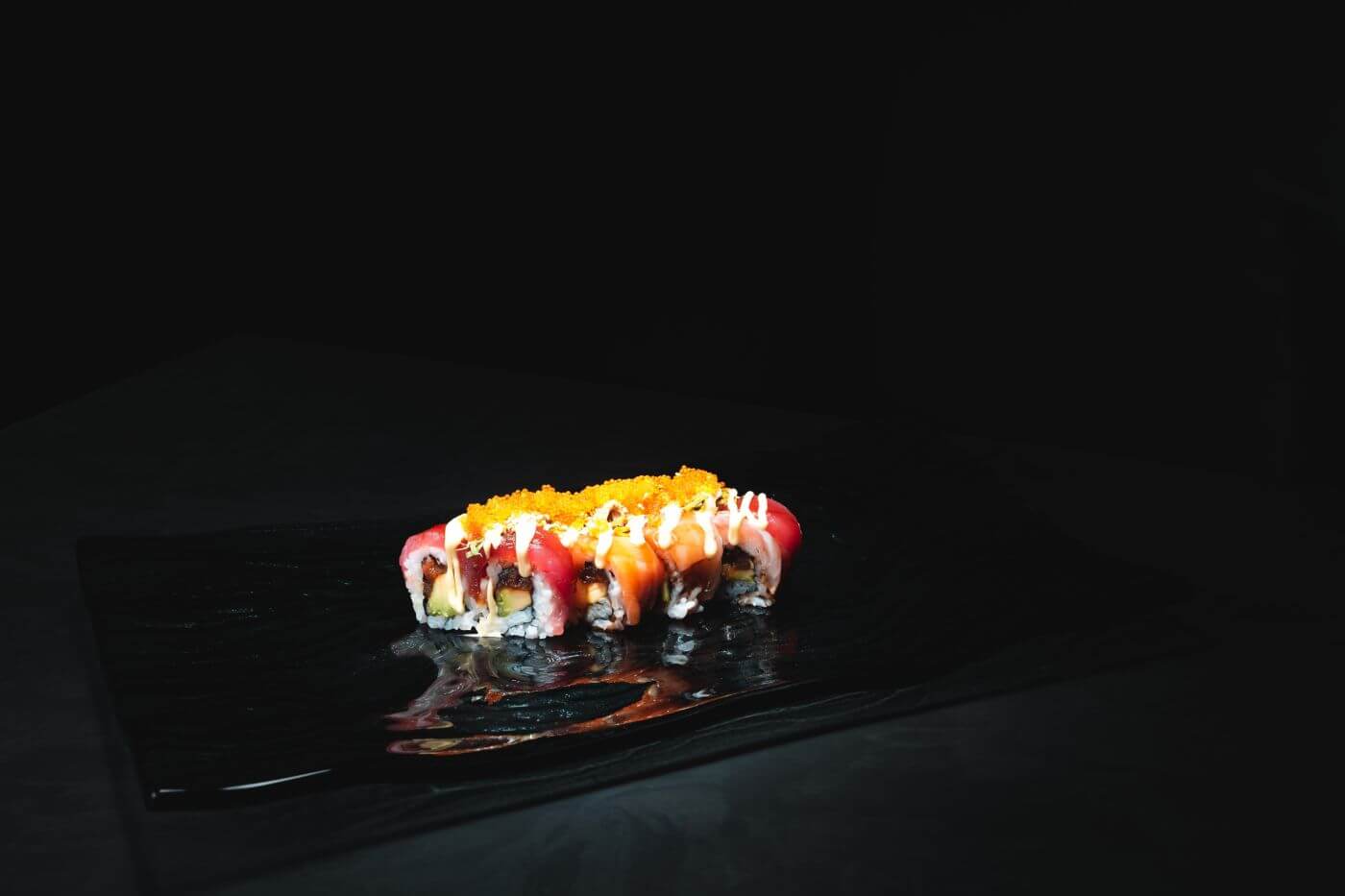 colorful sushi rolls on a black plate in Donaueschingen